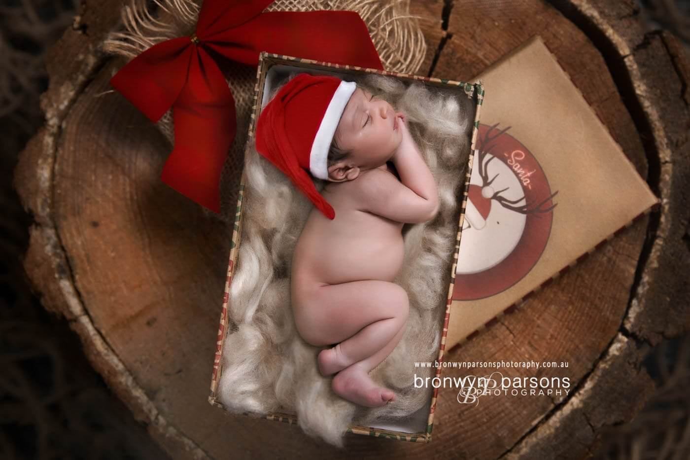 Baby Photography Canberra Baby in Santa Hat inside decorative christmas box for the holidays